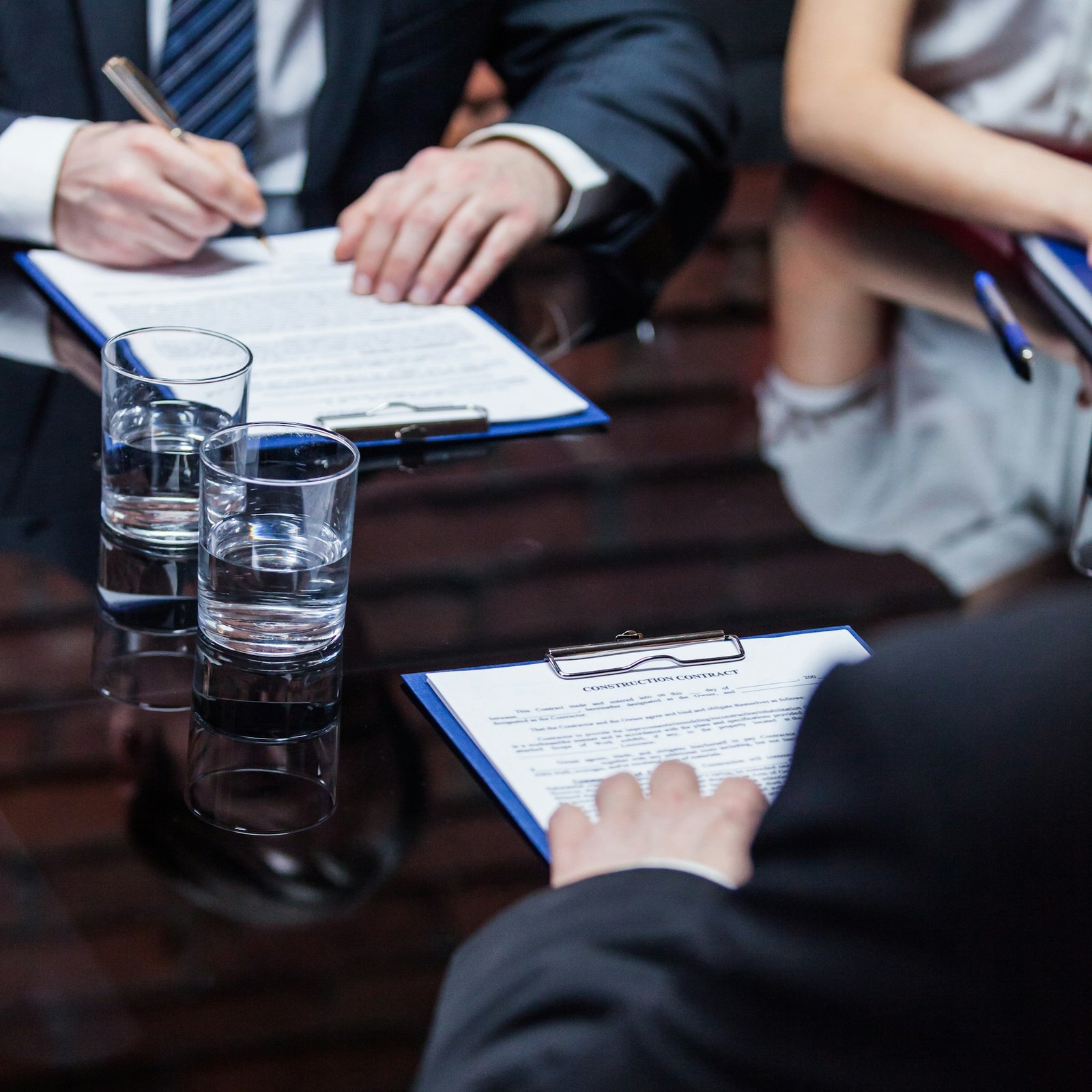 The businessmen giving signature to documents